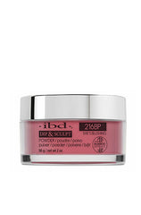 2 ounce clear glass jar containing ibd Dip & Sculpt She's Blushing nail powder dip