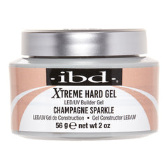 A jar of IBD Xtreme Hard Gel LED/UV Builder Gel in the shade Champagne Sparkle, featuring a metallic silver lid and a label with champagne glitter and white swooshes.